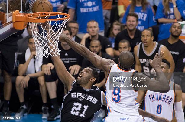 Tim Duncan of the San Antonio Spurs tries to drive past Serge Ibaka of the Oklahoma City Thunder during the second half of Game Six of the Western...