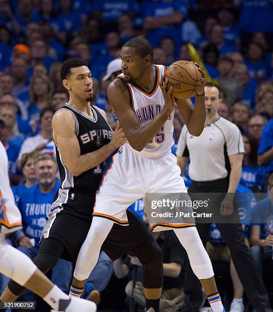 Kevin Durant of the Oklahoma City Thunder and Danny Green of the San Antonio Spurs battle for a ball during Game Six of the Western Conference...