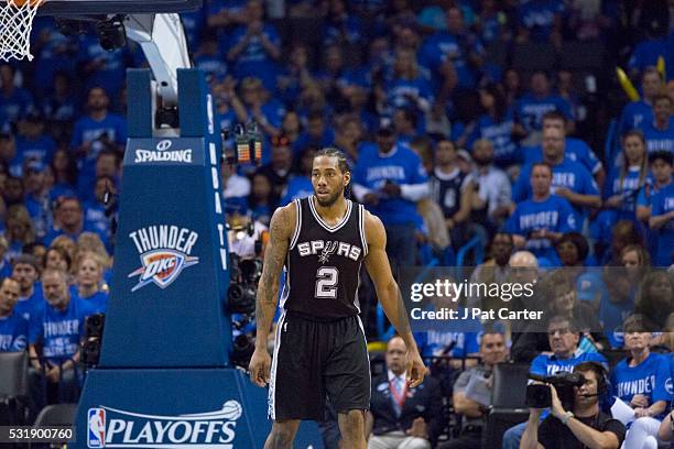 Kawhi Leonard of the San Antonio Spurs watches game action against the Oklahoma City Thunder during Game Six of the Western Conference Semifinals...