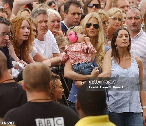 Gwyneth Paltrow holds her daughter Apple as she watches the performances during "Live 8 London" in Hyde Park on July 2, 2005 in London, England. The...