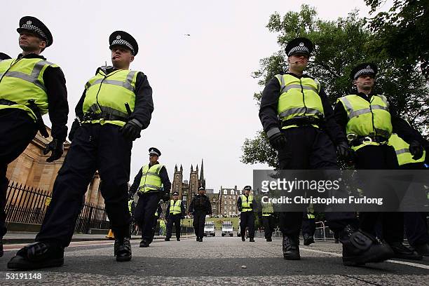Large police presence patrol the streets of Edinburgh as Campaigners from The Stop The war Coalition march through Edinburgh for a rally on Calton...