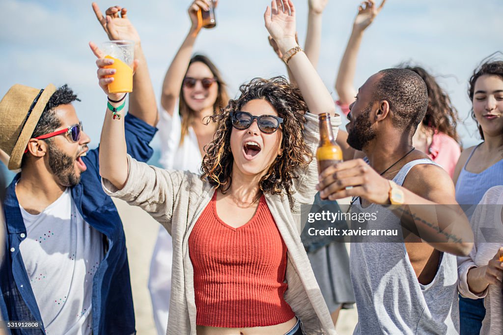 Friends having fun on a party at the beach