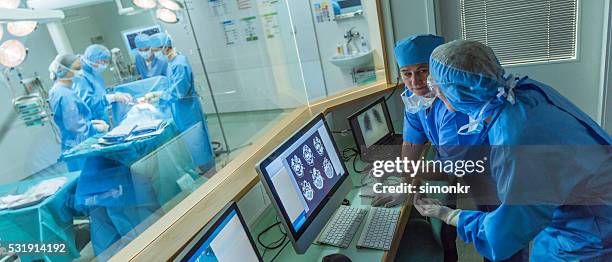 doctor working in hospital's control room - connecticut stock pictures, royalty-free photos & images