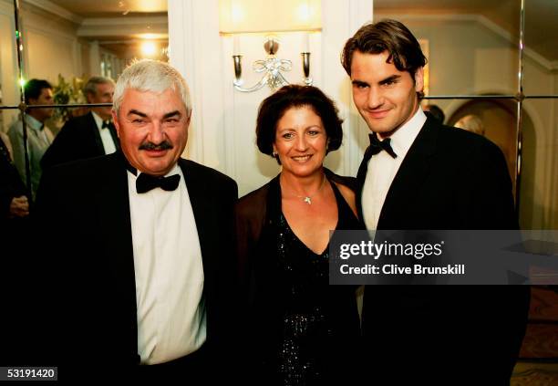 Roger Federer poses for a photo with his mother, Lynettee Federer, and father, Robert Federer as they arrive at the Wimbledon Winners Dinner on July...