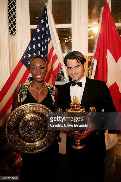 Venus Williams and Roger Federer pose with the trophies at the Wimbledon Winners Dinner at the Savoy Hotel on July 3, 2005 in London.