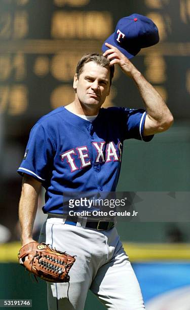 Starting pitcher Kenny Rogers of the Texas Rangers reacts after giving up a run in the 8th inning against the Seattle Mariners on July 3, 2005 at...