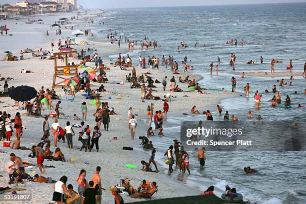 People enjoy a day at the beach July 3, 2005 in Pensacola, Florida. Florida has experienced a recent spate of shark attacks, with three in the last...
