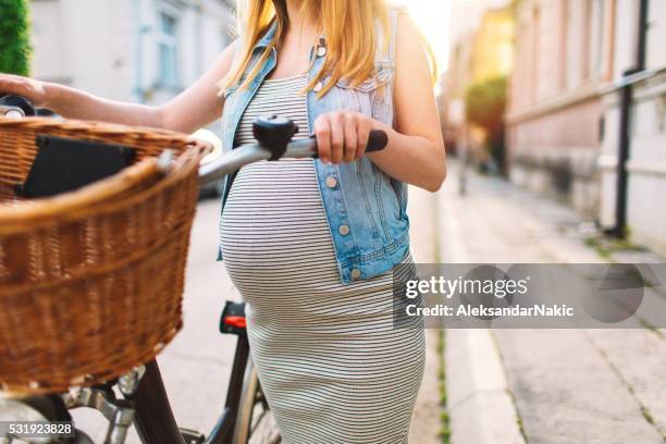 active pregnant woman - woman bicycle stock pictures, royalty-free photos & images