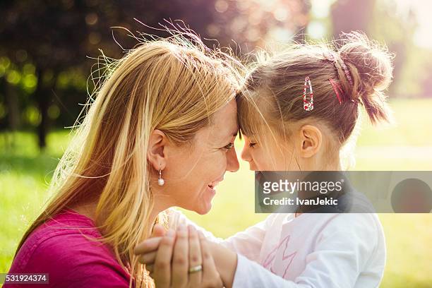 young mother hugging her daughter in nature - blind person stock pictures, royalty-free photos & images