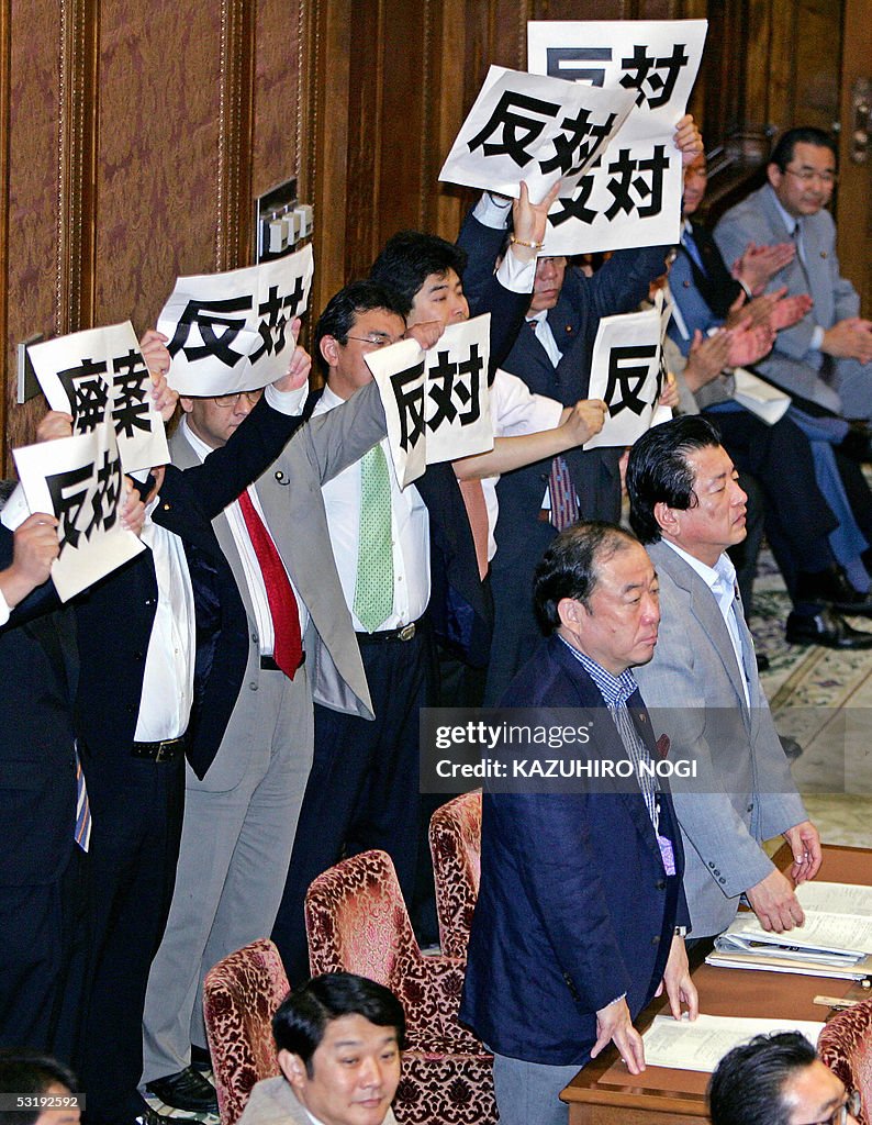 Members of the Opposition hold placards