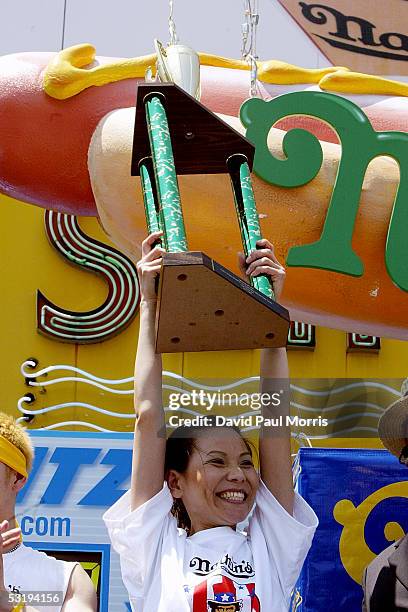 Sonya Thomas holds up her trophy after coming in second place in the annual Fourth of July International Hot Dog Eating Contest at Nathans Famous on...
