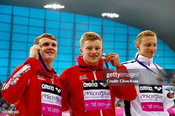 Ross Murdoch of Great Britain, Adam Peaty of Great Britain and Giedrius Titenis of Lithuania pose with their medals after the Men's 100m Breastroke...