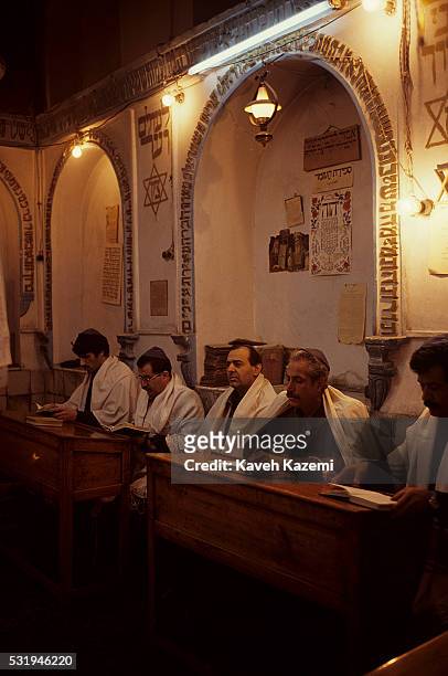 Men sit reading from Torah in Hakim Asher synagogue in south Tehran, 18th October 1992. Hakim Asher is the oldest Jewish synagogue situated off Cyrus...
