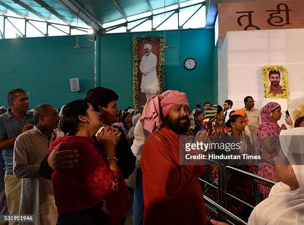Devotees stand in line to pay their last respects to mortal remains of Nirankari Baba Hardev Singh and his son-in-law Avneet Setya at Burari Ground...