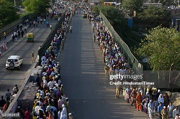 Devotees stand in line to pay their last respects to mortal remains of Nirankari Baba Hardev Singh and his son-in-law Avneet Setya at Burari Ground...