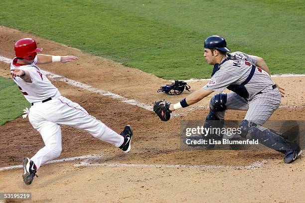 Adam Kennedy of the Los Angeles Angels of Anaheim is out at home plate by Joe Mauer of the Minnesota Twins in the 5th inning on July 4, 2005 at Angel...