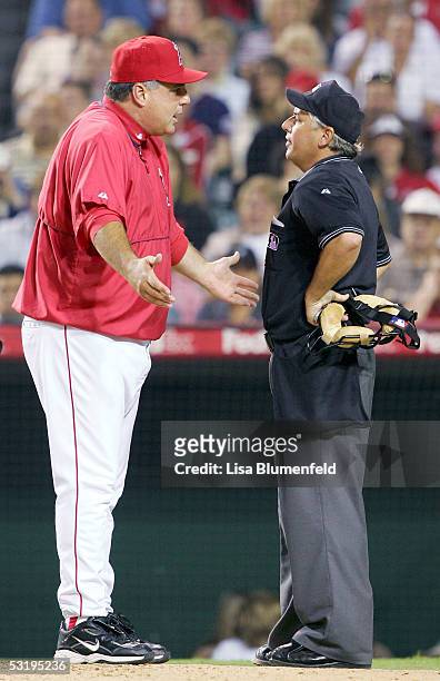 Manager Mike Scioscia of the Los Angeles Angels of Anaheim exchanges words with umpire Tom Hallion in the 9th inning against the Minnesota Twins on...