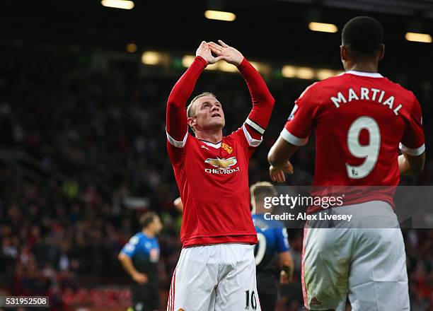 Wayne Rooney of Manchester United celebrates with Anthony Martial as he scores their first goal during the Barclays Premier League match between...