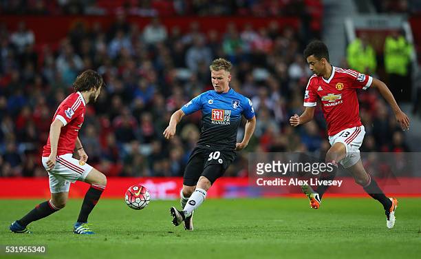 Matt Ritchie of Bournemouth is watched by Daley Blind and Cameron Borthwick-Jackson of Manchester United during the Barclays Premier League match...