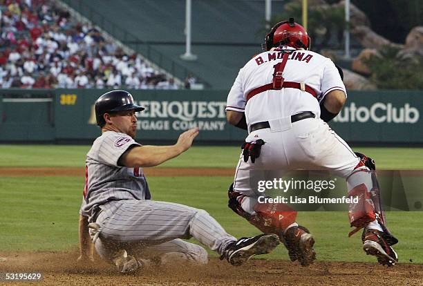 Lew Ford of the Minnesota Twins is safe at home plate against the Los Angeles Angels of Anaheim on July 4, 2005 at Angel Stadium in Anaheim,...