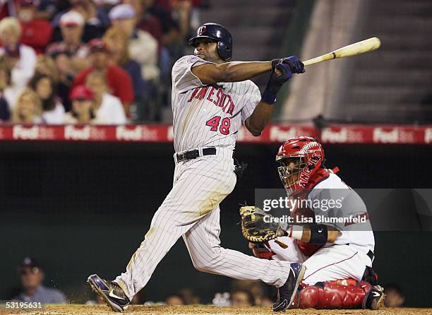 Torii Hunter of the Minnesota Twins hits a one run single in the 9th inning against the Los Angeles Angels of Anaheim on July 4, 2005 at Angel...