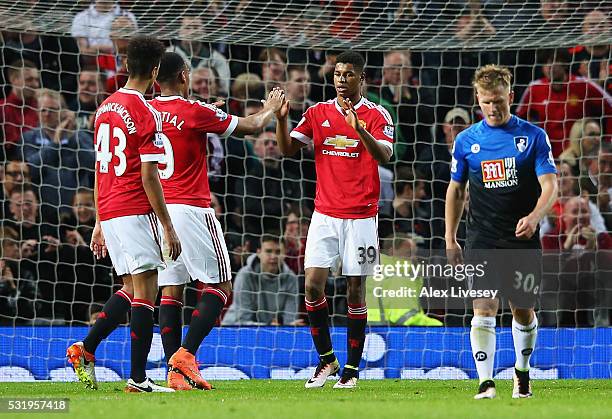 Marcus Rashford of Manchester United celebrates with Anthony Martial and Cameron Borthwick-Jackson as he scores their second goal during the Barclays...