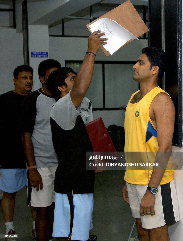 Indian cricketer Anil Kumble (R) stands