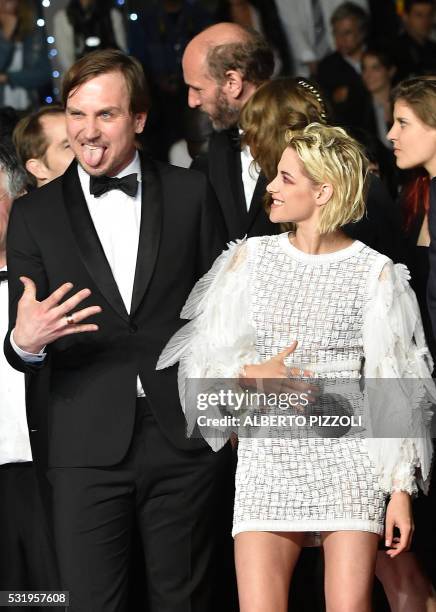 German actor Lars Eidinger and US actress Kristen Stewart dance on May 17, 2016 as they arrive for the screening of the film "Personal Shopper" at...