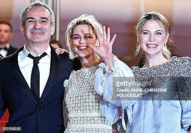 French director Olivier Assayas, US actress Kristen Stewart and Austrian actress Nora von Waldstatten pose as they arrive on May 17, 2016 for the...