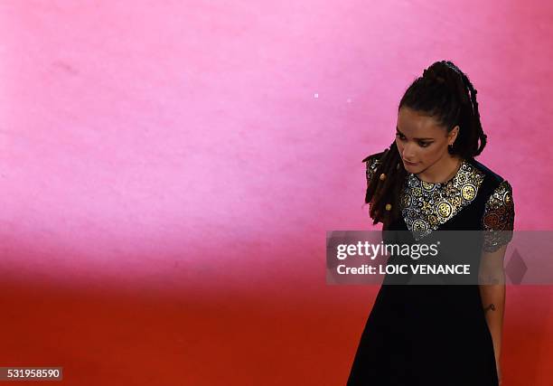 Actress Sasha Lane poses as she arrives on May 17, 2016 for the screening of the film "Personal Shopper" at the 69th Cannes Film Festival in Cannes,...