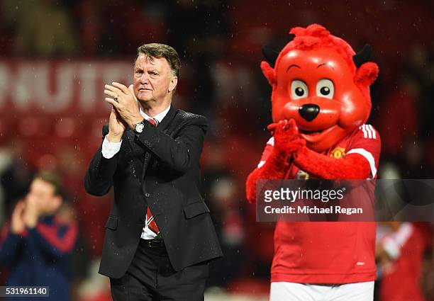 Louis van Gaal manager of Manchester United applauds the crowd alongside mascot Fred the Red after the Barclays Premier League match between...