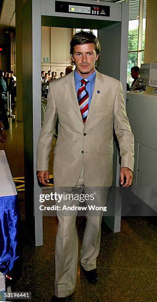 London 2012 sport ambassador and England footballer David Beckham walks through a security scanner upon arrival at the Opening Ceremony of the 117th...