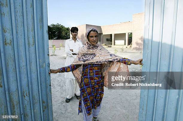 Mukhtiar Mai, who was gang raped by 6 men from a more powerful clan living next door on June 22 poses with her brother August 25, 2004 in...