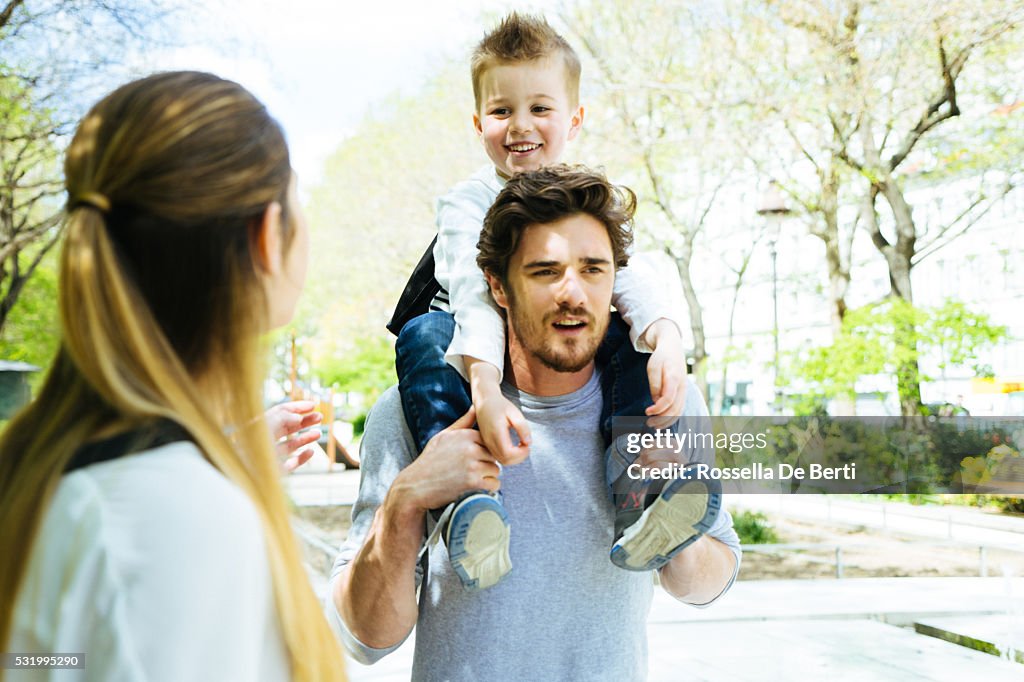 Happy Family Walking Through The Park Taking Son to School