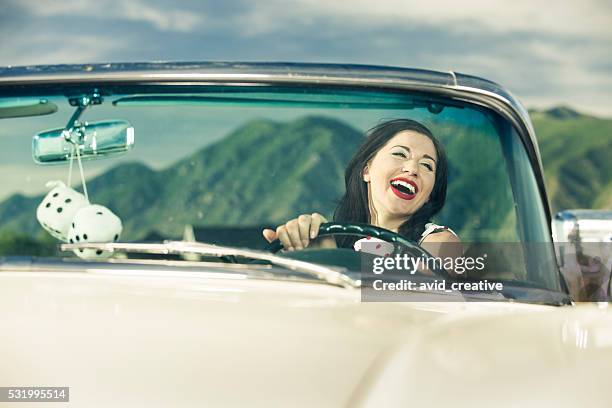 1950s woman laughing while driving car - 1950's cars stock pictures, royalty-free photos & images