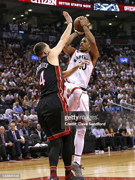 DeMar DeRozan of the Toronto Raptors shoots against Josh McRoberts of the Miami Heat in Game Five of the Eastern Conference Semifinals between the...