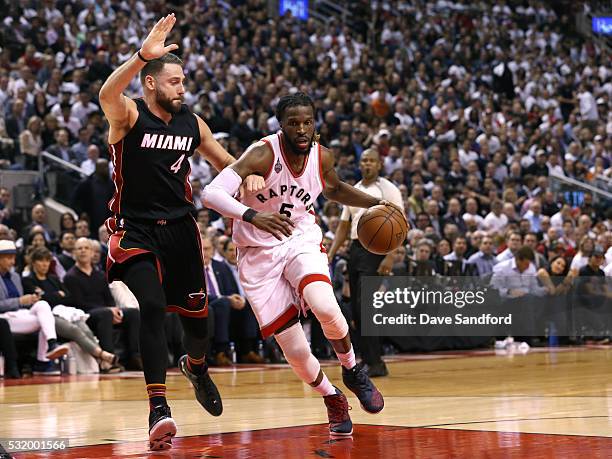 DeMarre Carroll of the Toronto Raptors drives to the basket against Josh McRoberts of the Miami Heat in Game Five of the Eastern Conference...