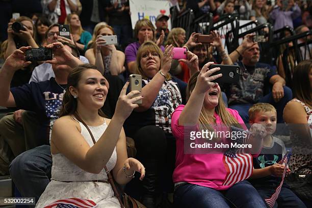 Family members photograph as their loved ones arrive to a welcome home ceremony for soldiers returning from Iraq on May 17, 2016 at Fort Drum, New...