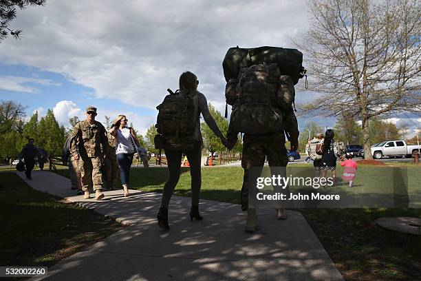 Couples walk after a welcome-home ceremony for soldiers returning from Iraq on May 17, 2016 at Fort Drum, New York. More than 1,000 members of the...