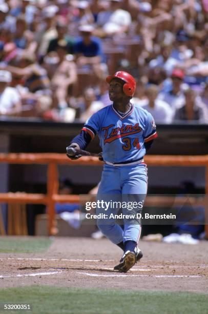 Kirby Puckett of the Minnesota Twins watches the flight of the ball as he follows through on his swing during a game against the California Angels at...