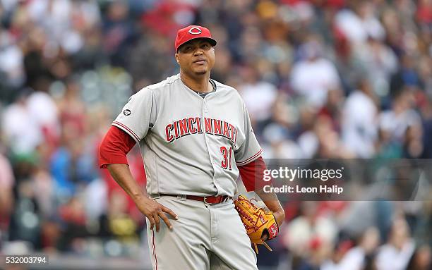 Alfredo Simon of the Cincinnati Reds reacts after giving up a single to Rajai Davis of the Cleveland Indians during the second inning of the...