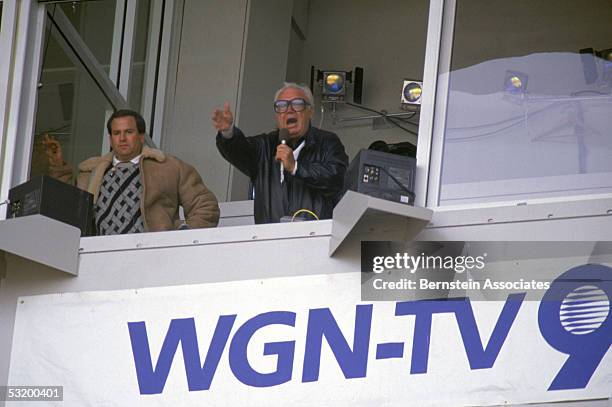 Chicago Cubs baseball announcer and Baseball Hall of Fame inductee Harry Caray conducts fans singing "Take Me Out to the Ball Game" from his...