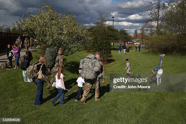 Family walks home from a welcome-home ceremony for soldiers returning from Iraq on May 17, 2016 at Fort Drum, New York. More than 1,000 members of...