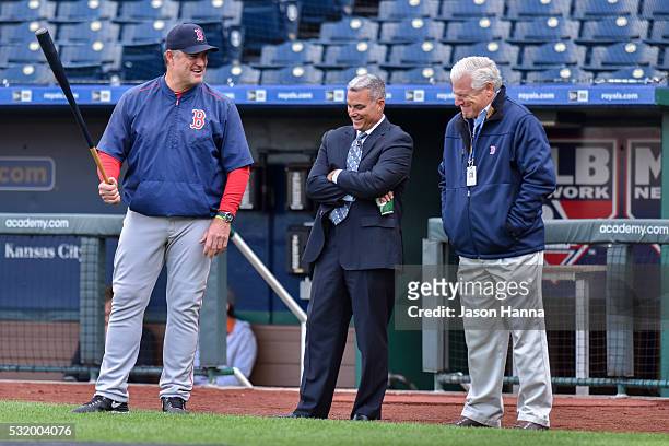 Kansas City Royals general manager Dayton Moore shares a laugh with Boston Red Sox senior vice president of baseball operations Frank Wren and...