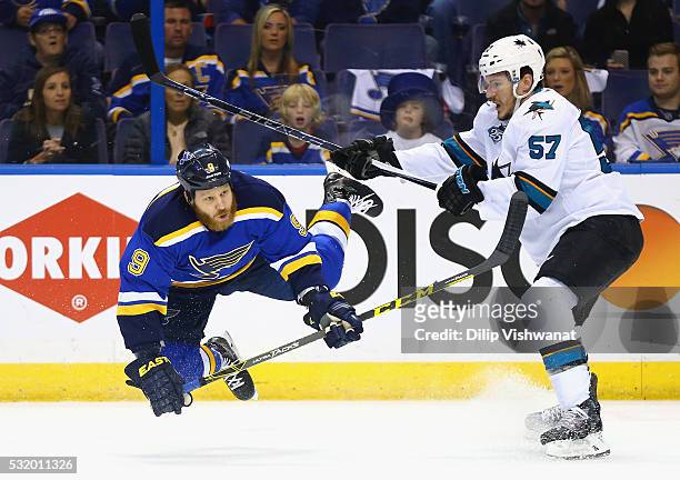 Steve Ott of the St. Louis Blues falls as Tommy Wingels of the San Jose Sharks looks on during the first period in Game Two of the Western Conference...