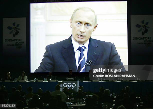 Russian President Vladimir Putin is seen giving a speech via video at the Moscow 2012 team's presentation to the 117th IOC Session at the Raffles...