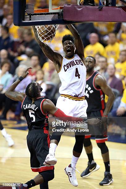 Iman Shumpert of the Cleveland Cavaliers dunks in the second quarter against DeMarre Carroll of the Toronto Raptors in game one of the Eastern...