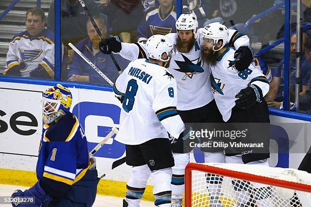 Brent Burns of the San Jose Sharks celebrates with Joe Thornton and Joe Pavelski after scoring a second period goal against Brian Elliott of the St....