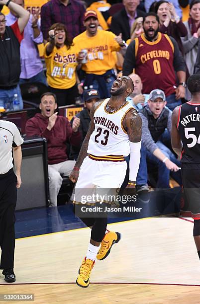 LeBron James of the Cleveland Cavaliers reacts after a basket in the second quarter against the Toronto Raptors in game one of the Eastern Conference...