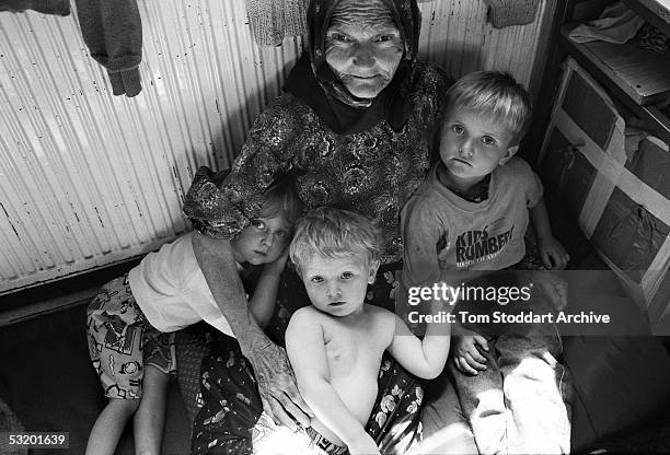 Srebrenica, BOSNIA A Muslim grandmother hugs her young grandchildren at a refugee centre set up near Tuzla for people fleeing the Srebrenica...